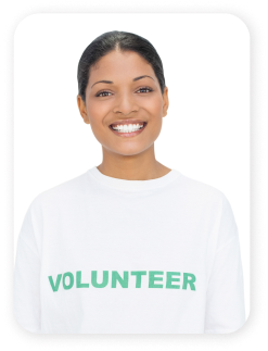 portrait of smiling woman with black hair wearing a volunteer t-shirt