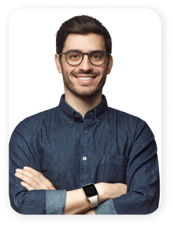 portrait of smiling dark haired man with arms folded in denim shirt