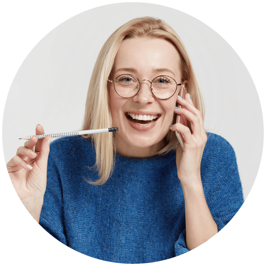 blonde lady smiling on the phone with a pen in her hand