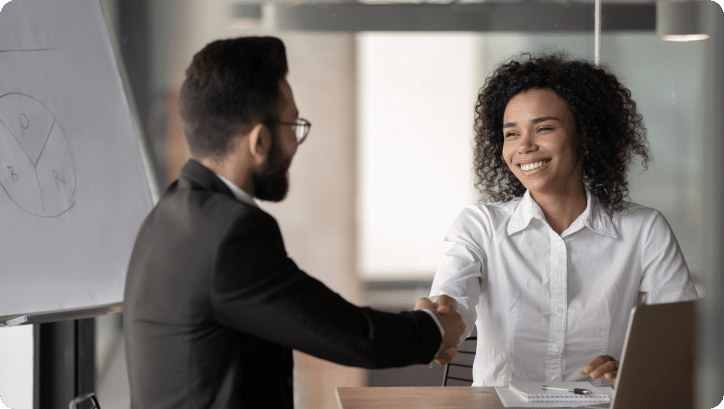 smiling business people shaking hands